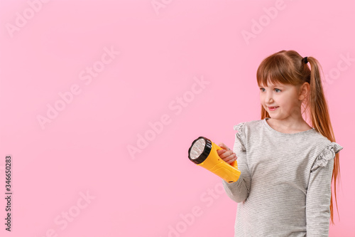Little girl with flashlight...