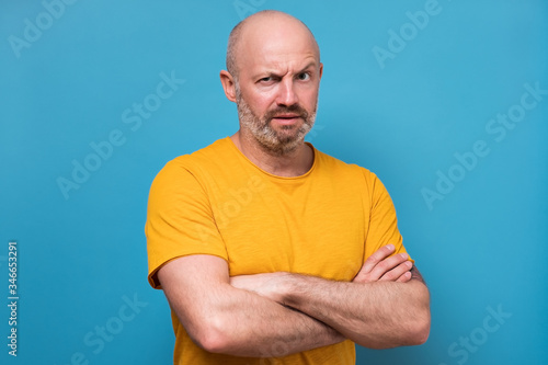 mature man looking with mistrust does not believe in news