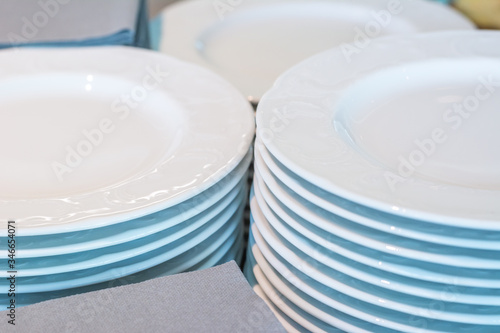 Closeup on stacks of white plates and napkins