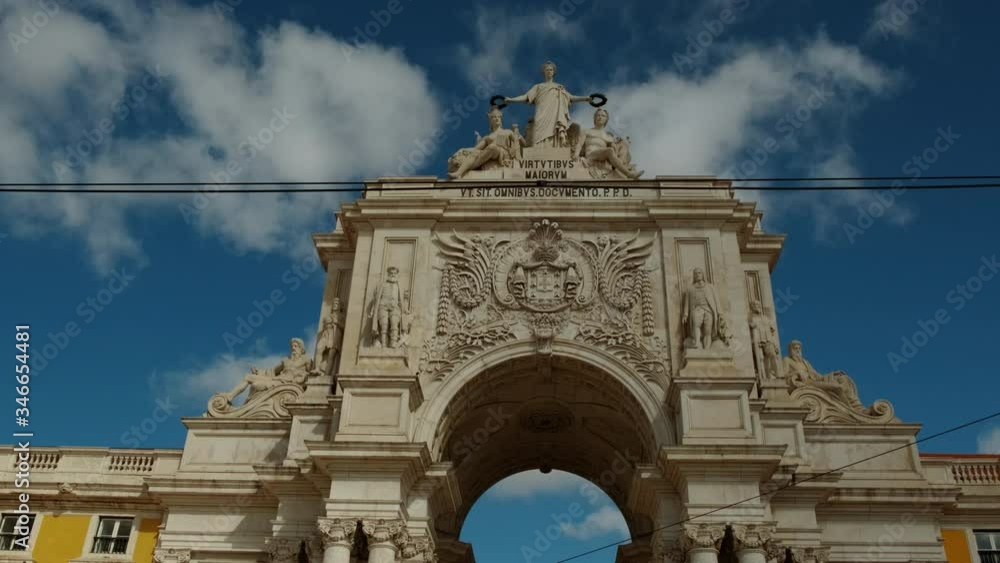 Dramatic shot of the Rua Augusta Arch in Lisbon, Portugal. The stone, triumphal arch-like building dates back to 1873 Dramatic shot of the Rua Augusta Arch in Lisbon, Portugal. The stone, triumphal arch-like building dates back to 1873