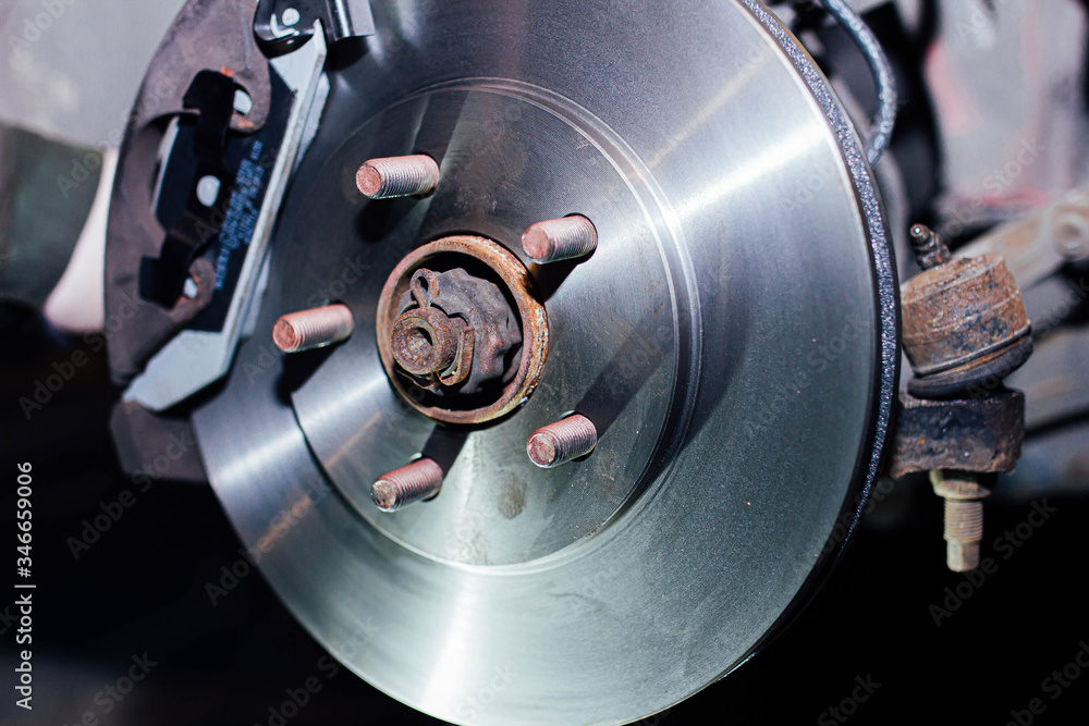 installing a new brake disc in the car. repair of brake systems. installing a new brake disc in the car. repair of brake systems.