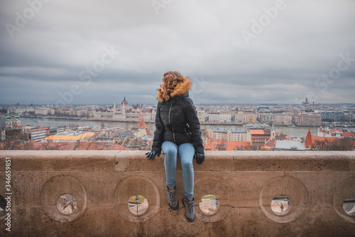 Canvas Print Young woman in the fishermen's bastion in Budapest, in the background the budape