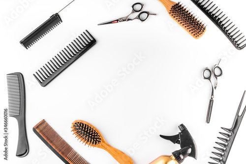 Hairdressing equipment. Combs, scissors on white desk top-down frame space for text