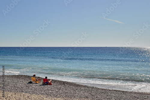 Two people lying on the beach and enjoy the view and your holiday.