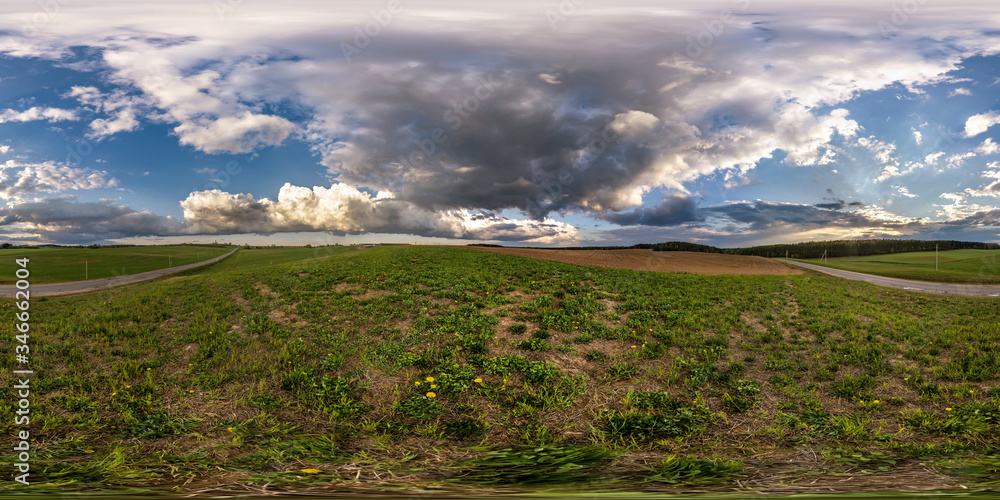 Obraz premium full seamless spherical hdri panorama 360 degrees angle view on among fields in spring evening with awesome clouds before storm in equirectangular projection, ready for VR AR virtual reality content