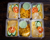 Hyderabad Dum Biryani in a takeaway box. Food delivery halal food concept in Malaysia.