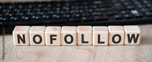 Nofollow links - concept text on wooden cubes and in the background black keyboard photo