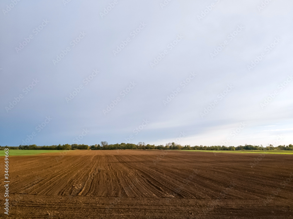 Brown soil of a cultivated field - agricultural background