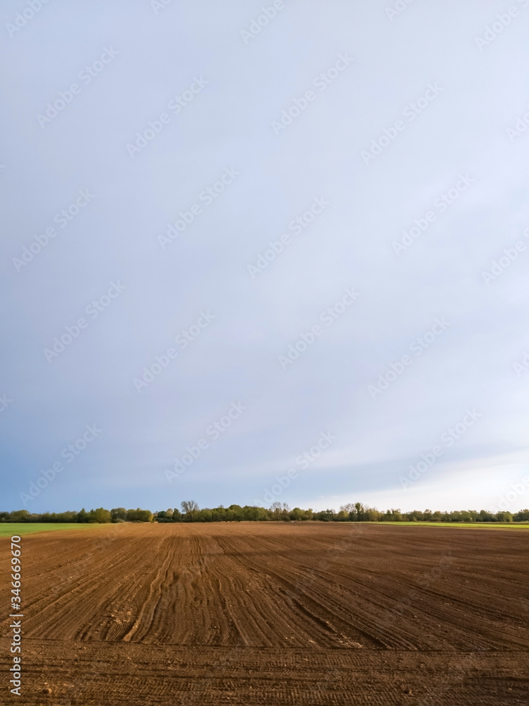 Brown soil of a cultivated field - agricultural background Brown soil of a cultivated field - agricultural background