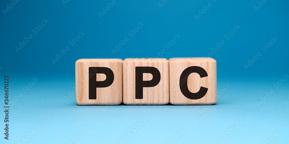 PPC website - text concept on wooden cubes with gradient blue background PPC website - text concept on wooden cubes with gradient blue background