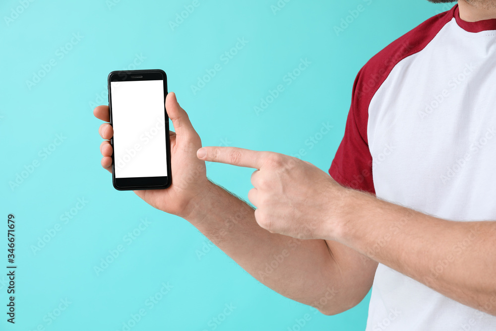 Man with mobile phone on color background
