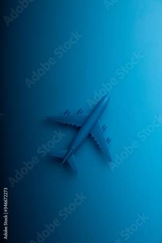 Blue model airplane on a gradient background of pastel color with a copy of the space flat design lying down