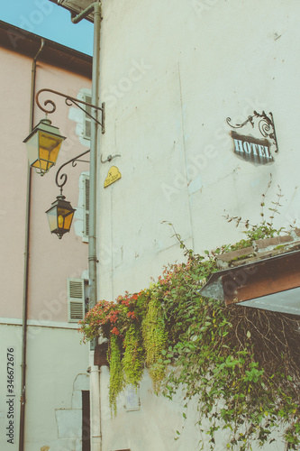 Old street lamps and a vintage hotel sign, Annecy, France.