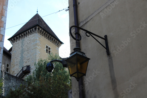 Vintage old lamp, CCTV camera and the Castle of Annecy in the background, Annecy, France.