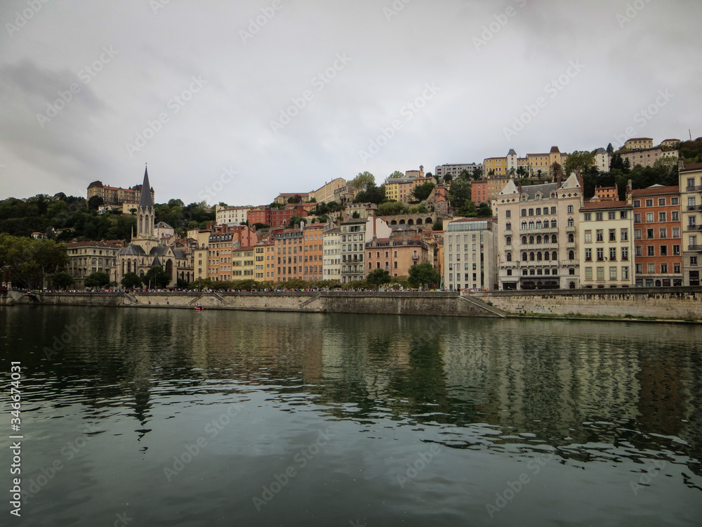 Heading into Vieux Lyon over the Pont Bonaparte. Quai Fulchiron on the banks of the Saone river, Passerelle, Saint Georges church and Saint-Just College on Fourviere hill.