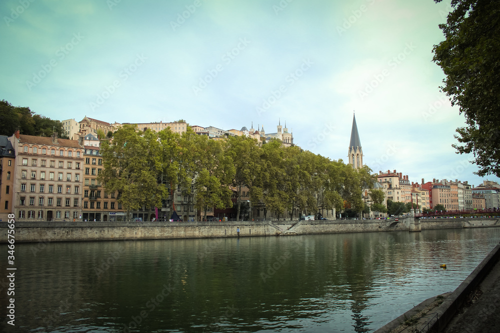 Obraz premium Church of St George with buildings along the Saone River, Quai Fulchiron (quay), in the Old City of Lyon, in the 5th arrondissement (district), Passerelle Saint-Georges bridge, and the Fourviere hill.