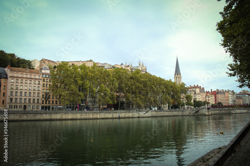 Church of St George with buildings along the Saone River, Quai Fulchiron (quay), in the Old City of Lyon, in the 5th arrondissement (district), Passerelle Saint-Georges bridge, and the Fourviere hill.