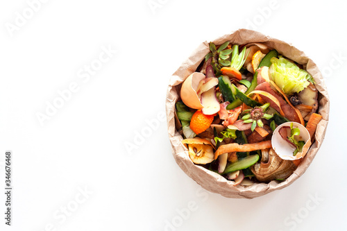 Cuadro en lienzo Organic food waste in paper bag on white kitchen table