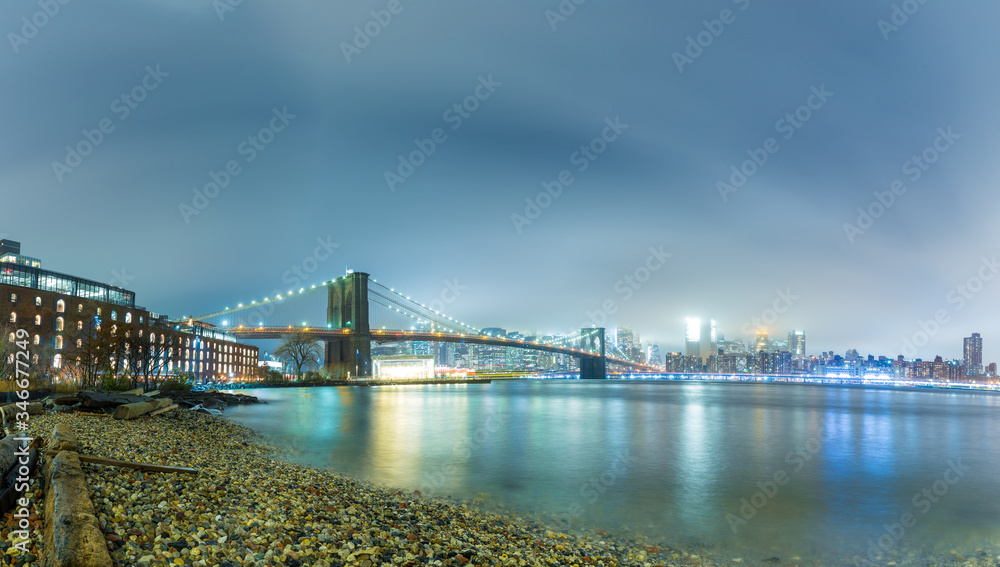 Dumbo between the Manhattan and Brooklyn Bridges in NYC at night, panorama and long exposition,
