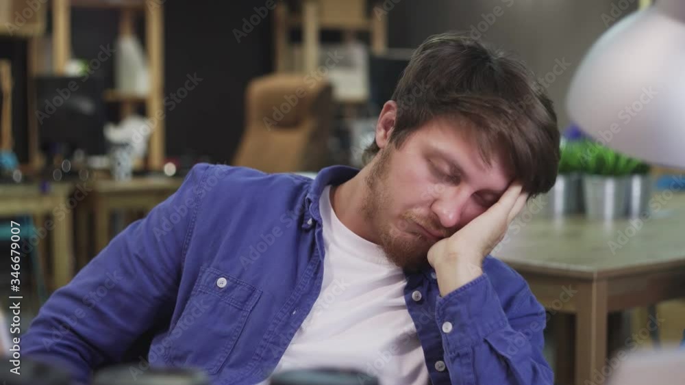 Young tired businessman sleeps at the office Young tired businessman sleeps at the office