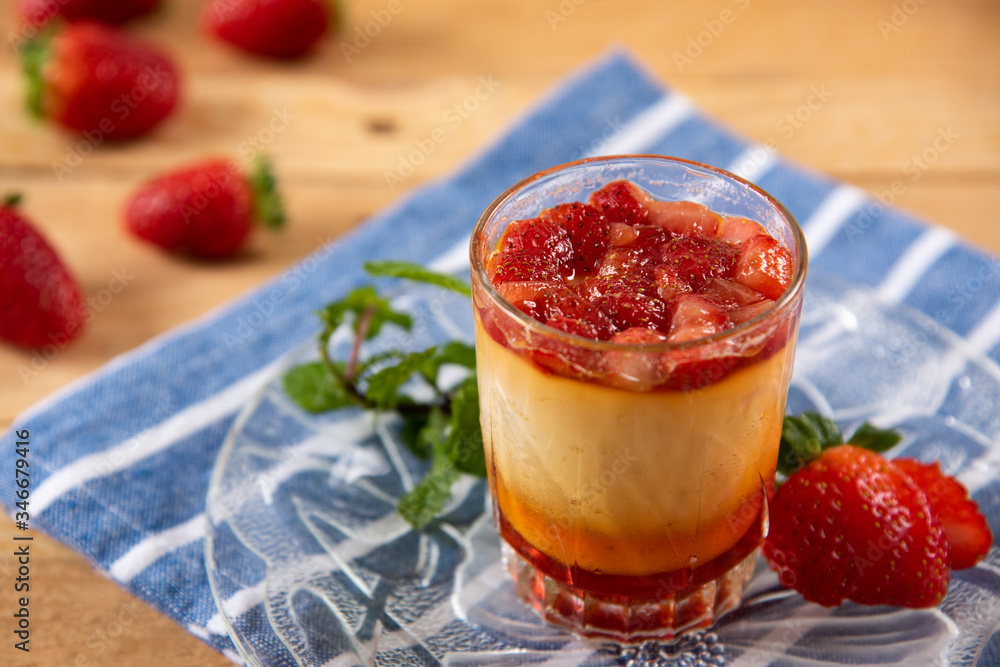 Apricot panacota surrounded by strawberries Apricot panacota surrounded by strawberries