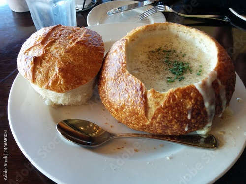 Photography Clam Chowder Bread Bowl, San Francisco, California, USA - A delicious bowl of clam chowder in a sourdough bread bowl on a white plate in San Francisco