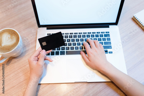 Paying online with credit card and laptop.