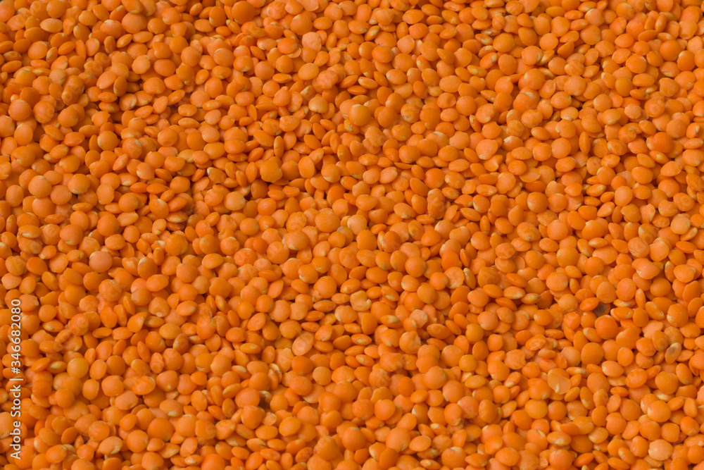 Texture of bright orange lentils. Healthy food for vegans, vegetarians. Horizontal position. Top view. Texture of bright orange lentils. Healthy food for vegans, vegetarians. Horizontal position. Top view.