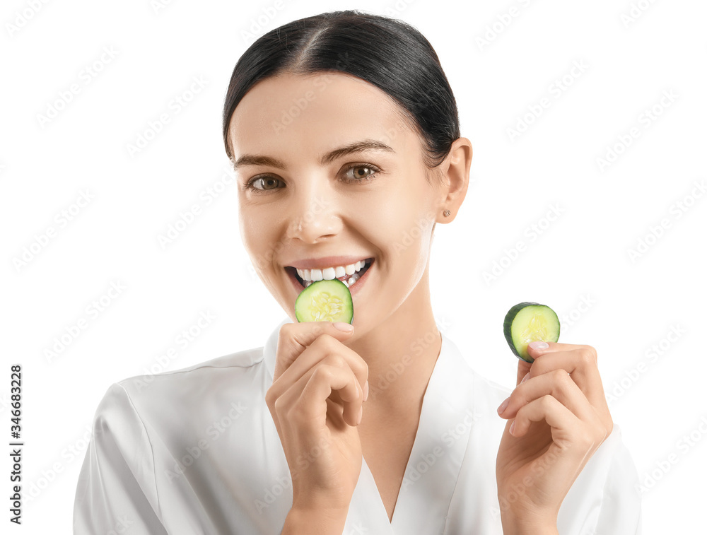 Beautiful young woman with cucumber slices on white background Beautiful young woman with cucumber slices on white background