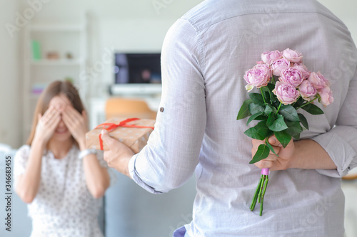 Man giving bouquet of flowe...