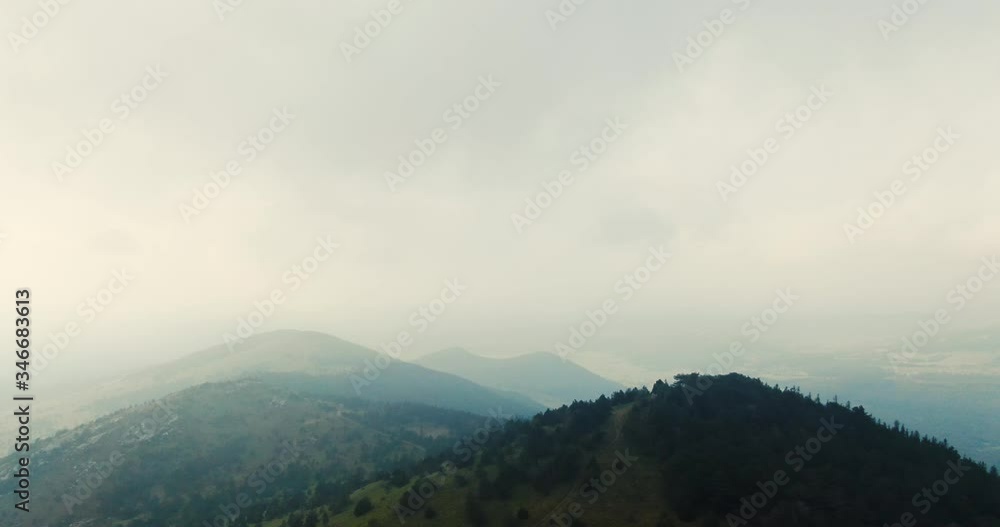 Filming on the top of the mountain, nothing man made in view all pure nature. A bit of a moody vibe with light passing trough clouds. Filming on the top of the mountain, nothing man made in view all pure nature. A bit of a moody vibe with light passing trough clouds.