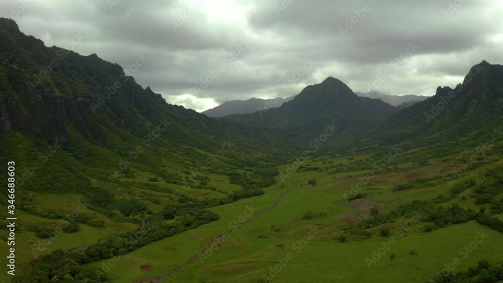 Heavy clouds hang over the Hollywood mountain film location, Kualoa Ranch, Oahu, aerial dolly Heavy clouds hang over the Hollywood mountain film location, Kualoa Ranch, Oahu, aerial dolly