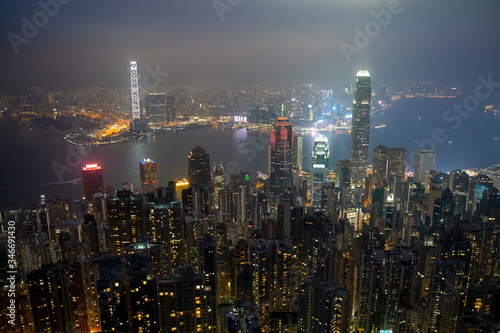 Lugard Road, Hoang Kong - January 1, 2020: Aerial view of night scene at Hong Kong city skyline during misty and hazy sky.