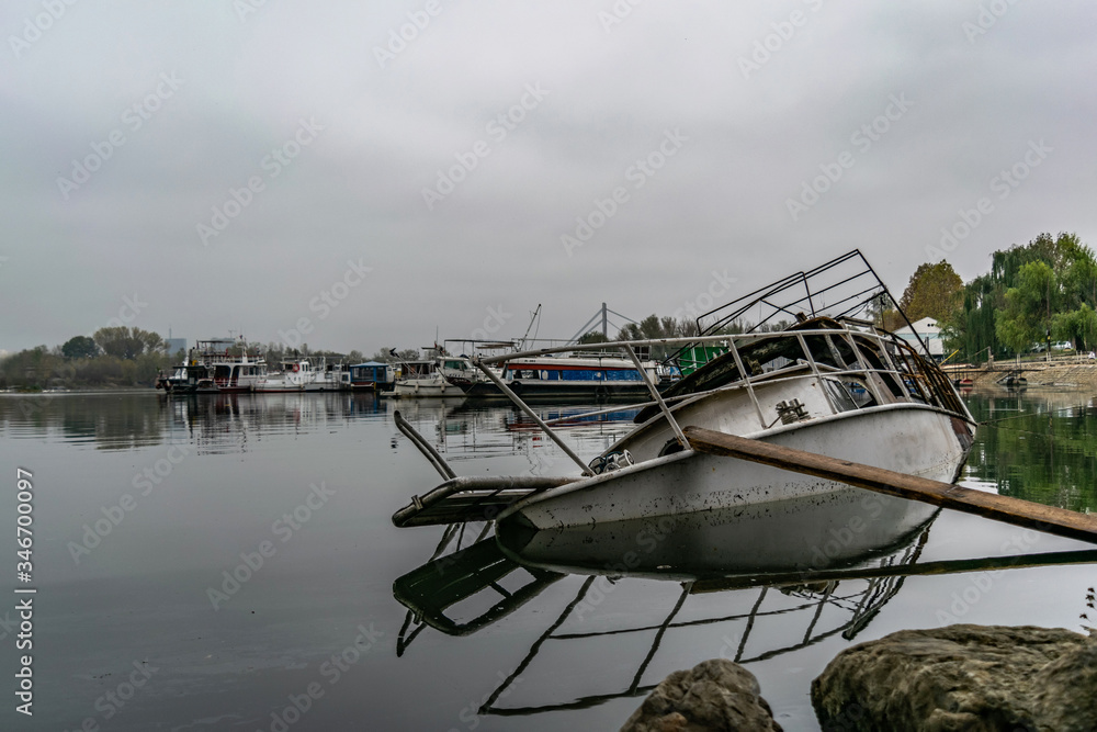 Abandoned fishing boat half-sunk near coast