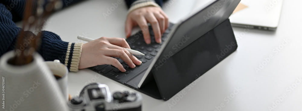 Cropped shot of female freelancer working on modern worktable