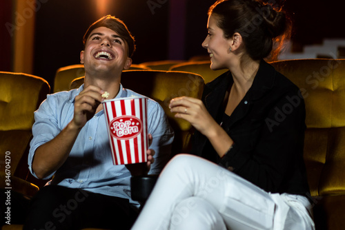 Man and woman watching movie in the movie theater cinema. Group recreation activity and entertainment concept. photo