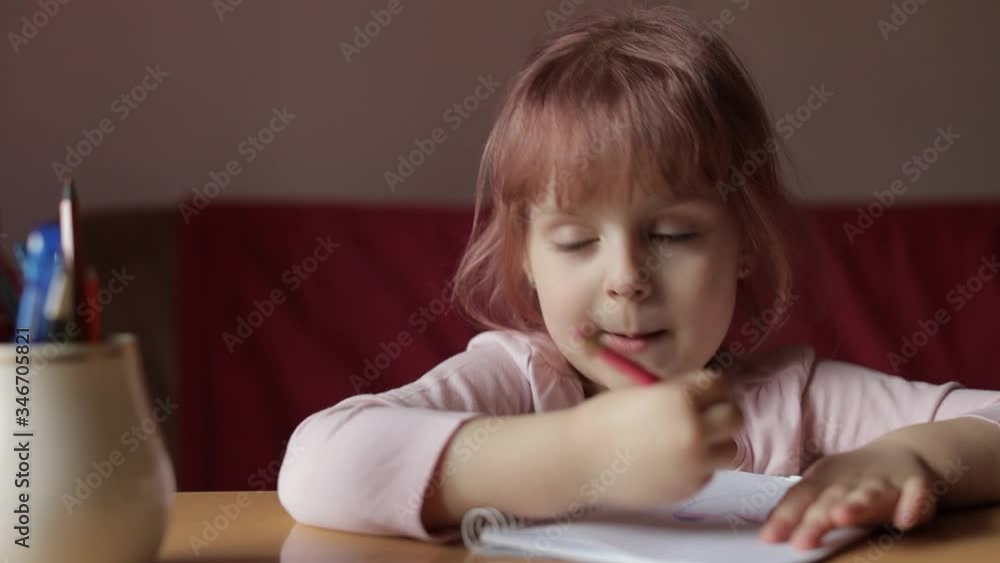 Cute child girl artist studying drawing picture with pen and pencils at home Cute child girl artist studying drawing picture with pen and pencils at home