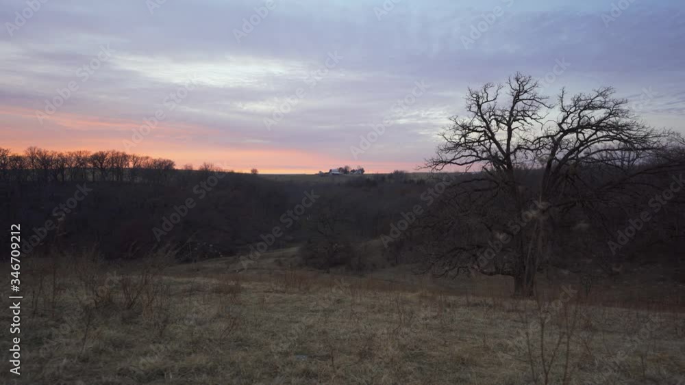 Sunset in rural Wisconsin with farm in the distance. Sunset in rural Wisconsin with farm in the distance.