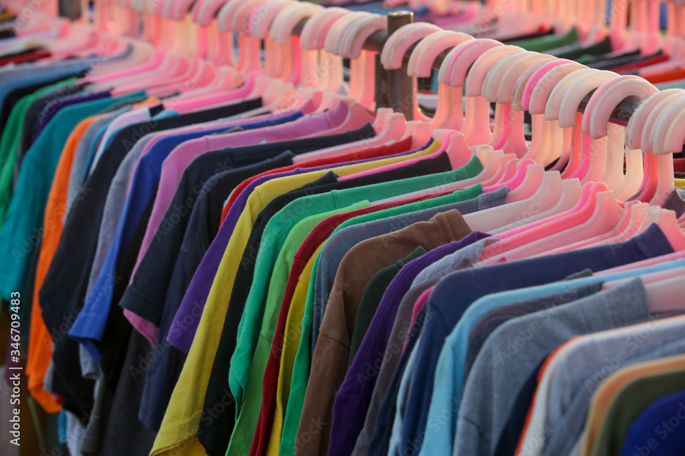 Huge selection of different used clothes for men, women and children on the  rack in a second hand shop or thrift store. Concept of waste problem in  fashion industry. Stock Photo