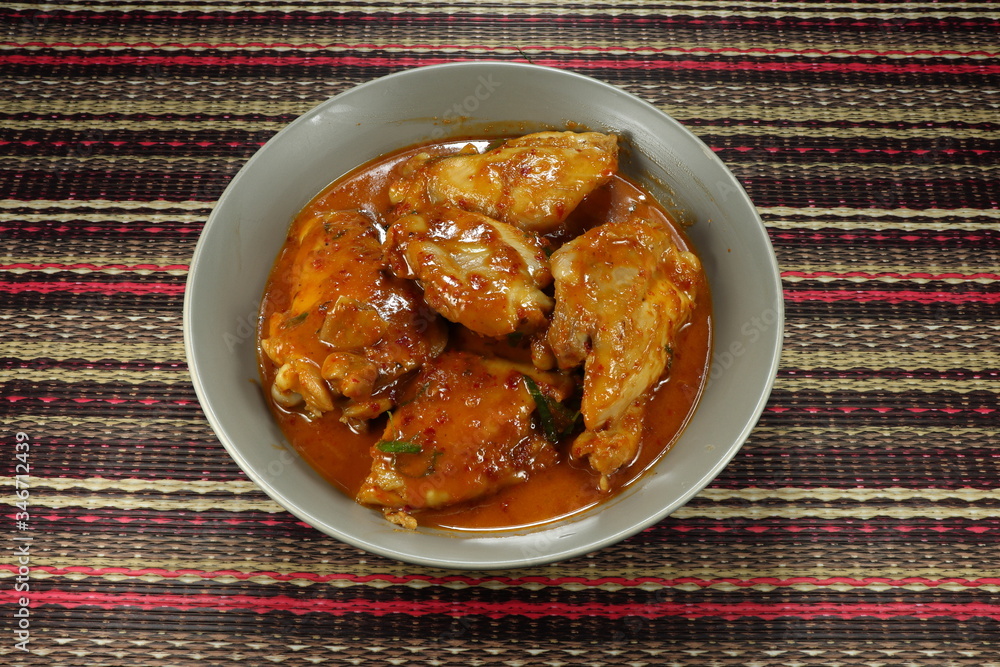 Traditional soup of chicken thigh with red Thai curry paste and coconut