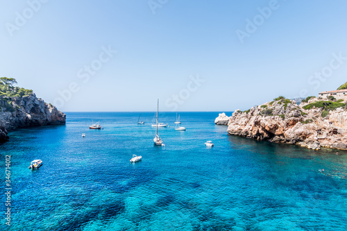 Landscape of boats, sea and mountains in Cala Deia, Majorca