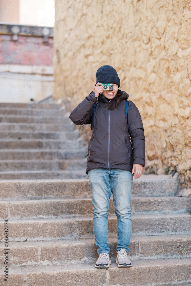 Hipster woman traveler with sweater and backpack traveling in Songzanlin Temple, happy Film Photographer taking photo in trip Zhongdian city ( Shangri-La) Yunnan, China. Asia and Solo travel concept Hipster woman traveler with sweater and backpack traveling in Songzanlin Temple, happy Film Photographer taking photo in trip Zhongdian city ( Shangri-La) Yunnan, China. Asia and Solo travel concept