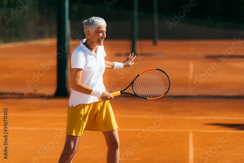 Active Senior Lady in her 60s Playing Recreational Tennis © Microgen