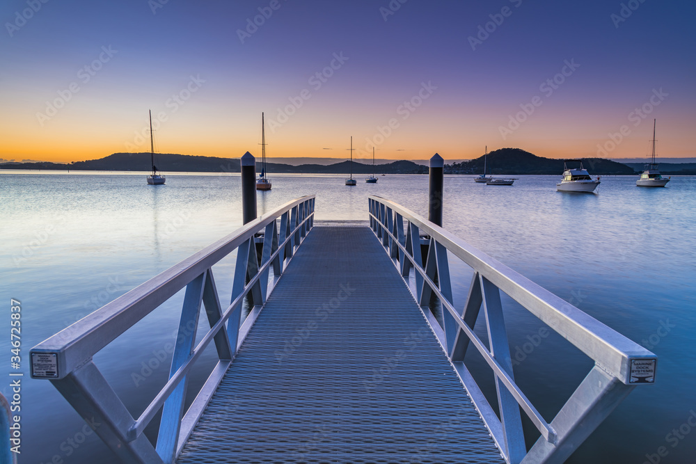 Sunrise, boats and wharf waterscape