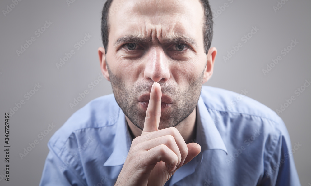 Man making silence gesture, pst. Secret Man making silence gesture, pst. Secret