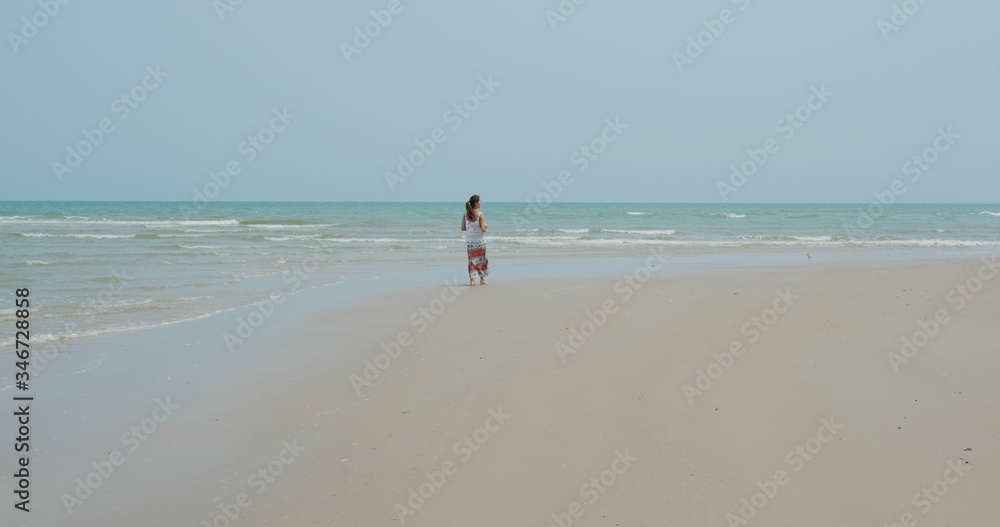 Woman walk in the beach