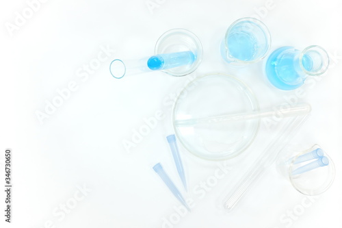 Wallpaper Mural Laboratory experiment flat lay composition. Blue chemicals in white background  Torontodigital.ca