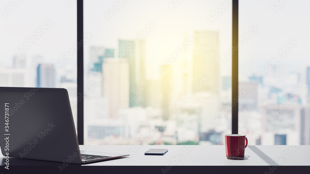 3D rendering. office workplace with notebook laptop,and coffee cup on city skyline background.