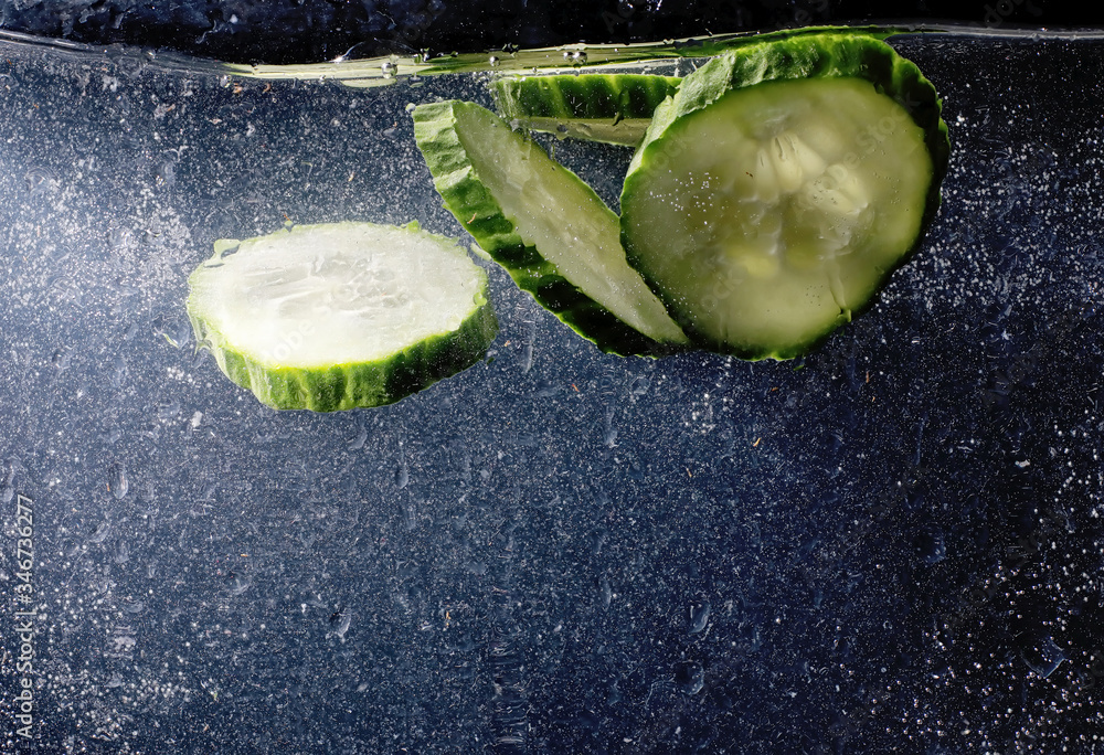 Water drops on ripe cucumber. Fresh vegetables background with copy space for your text. Vegan concept. - obrazy, fototapety, plakaty 