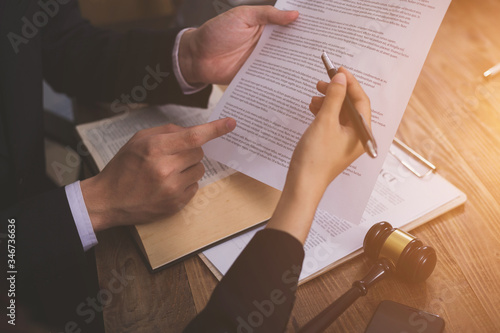 The hard work of an asian lawyer in a lawyer's office. Counseling and giving advice and prosecutions about the invasion of space between private and government officials to find a fair settlement.